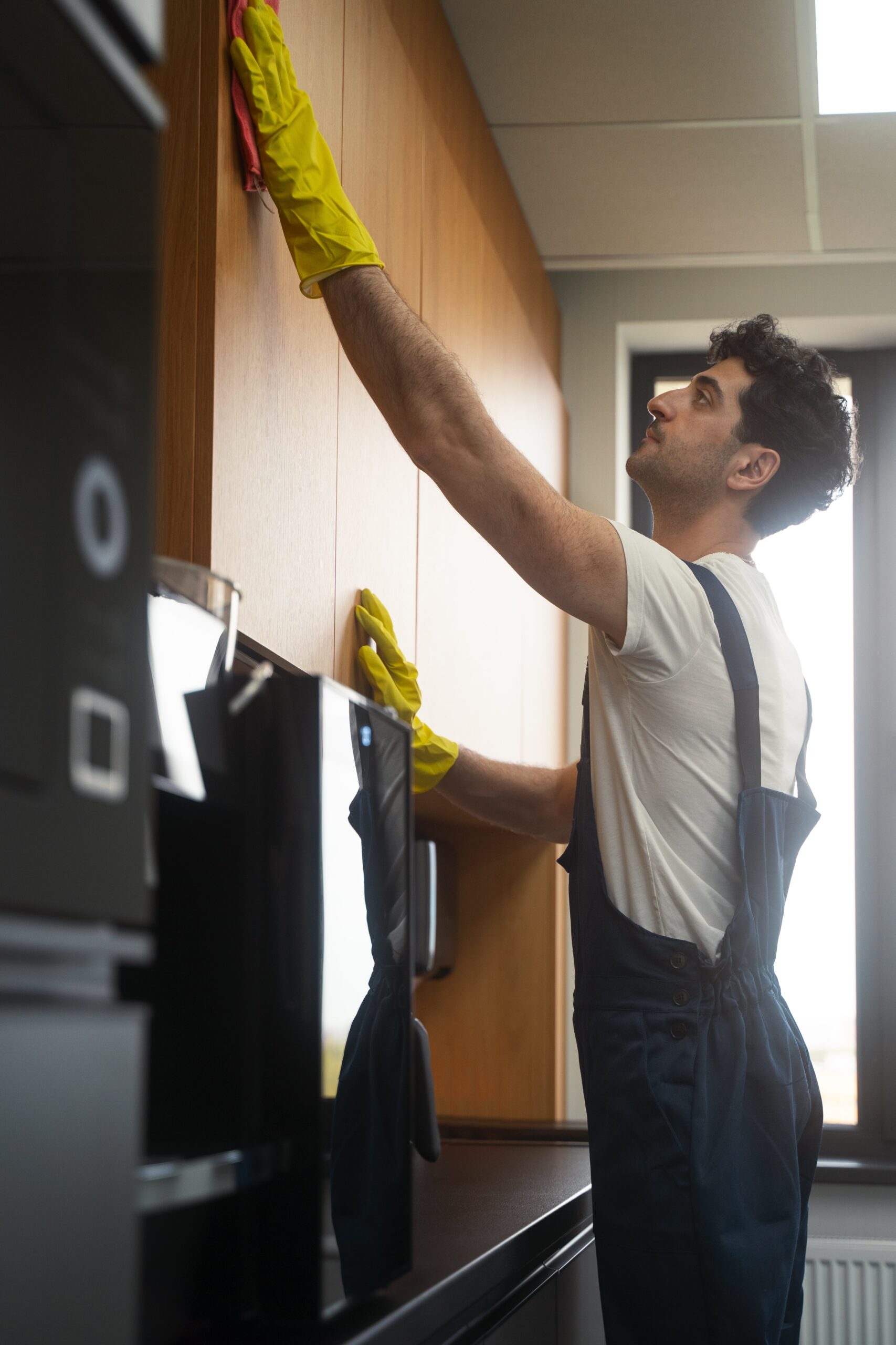 medium-shot-man-cleaning-indoors-min (1)